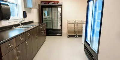 Bar area with counters, commercial fridges.