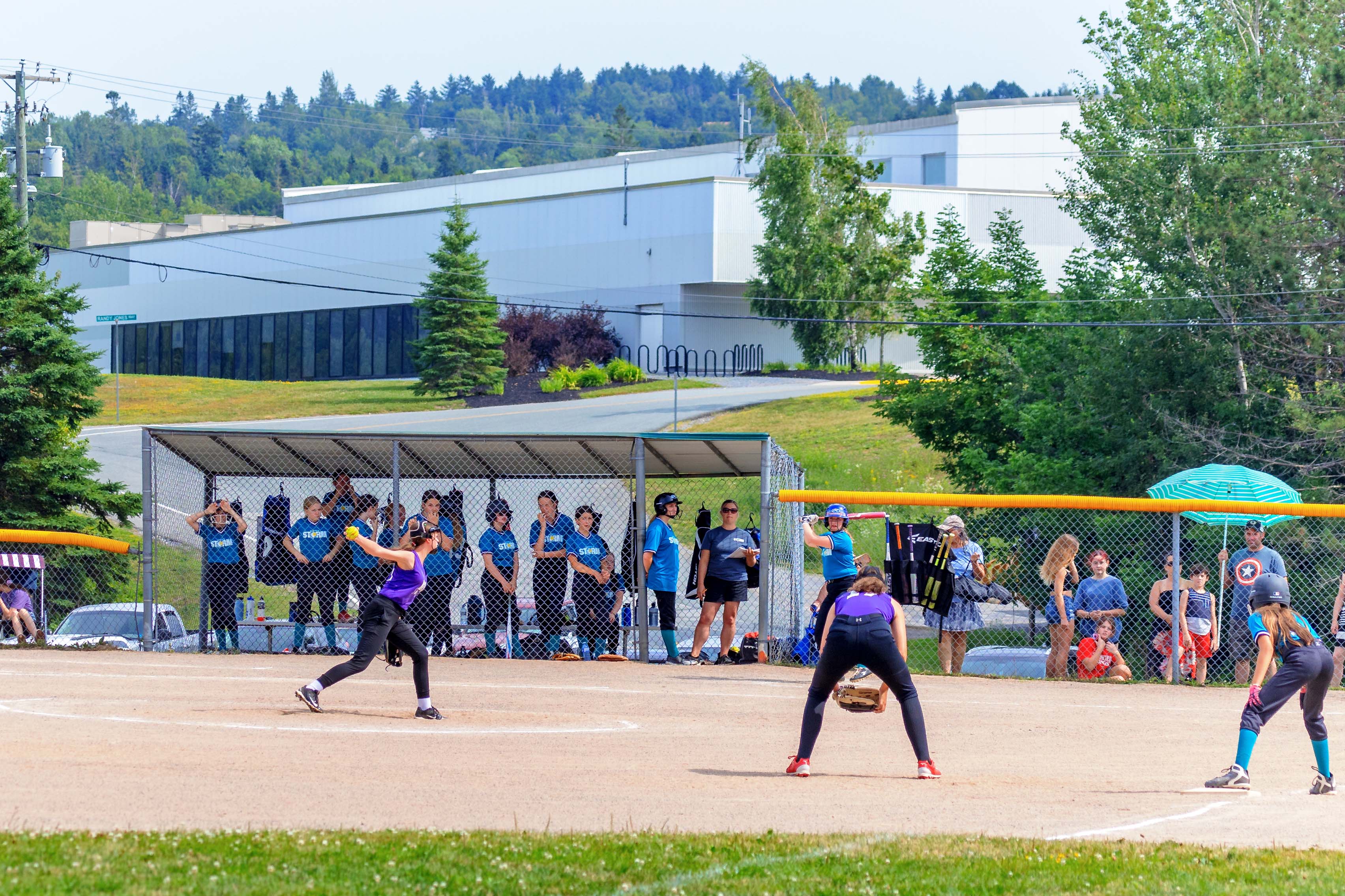 Group of women on baseball pitch playing baseball.